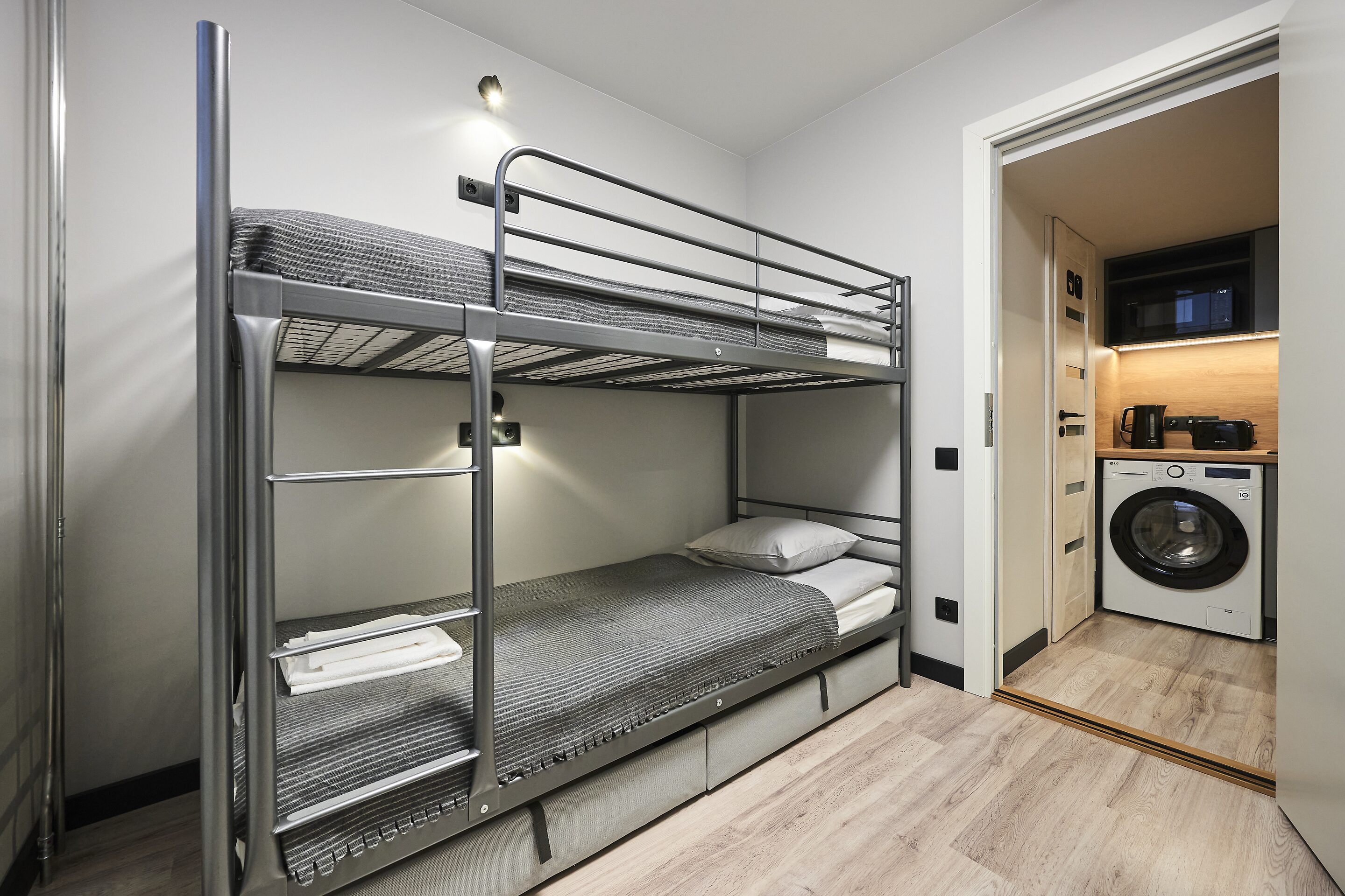 Four-bed dorm with the door open to the kitchen